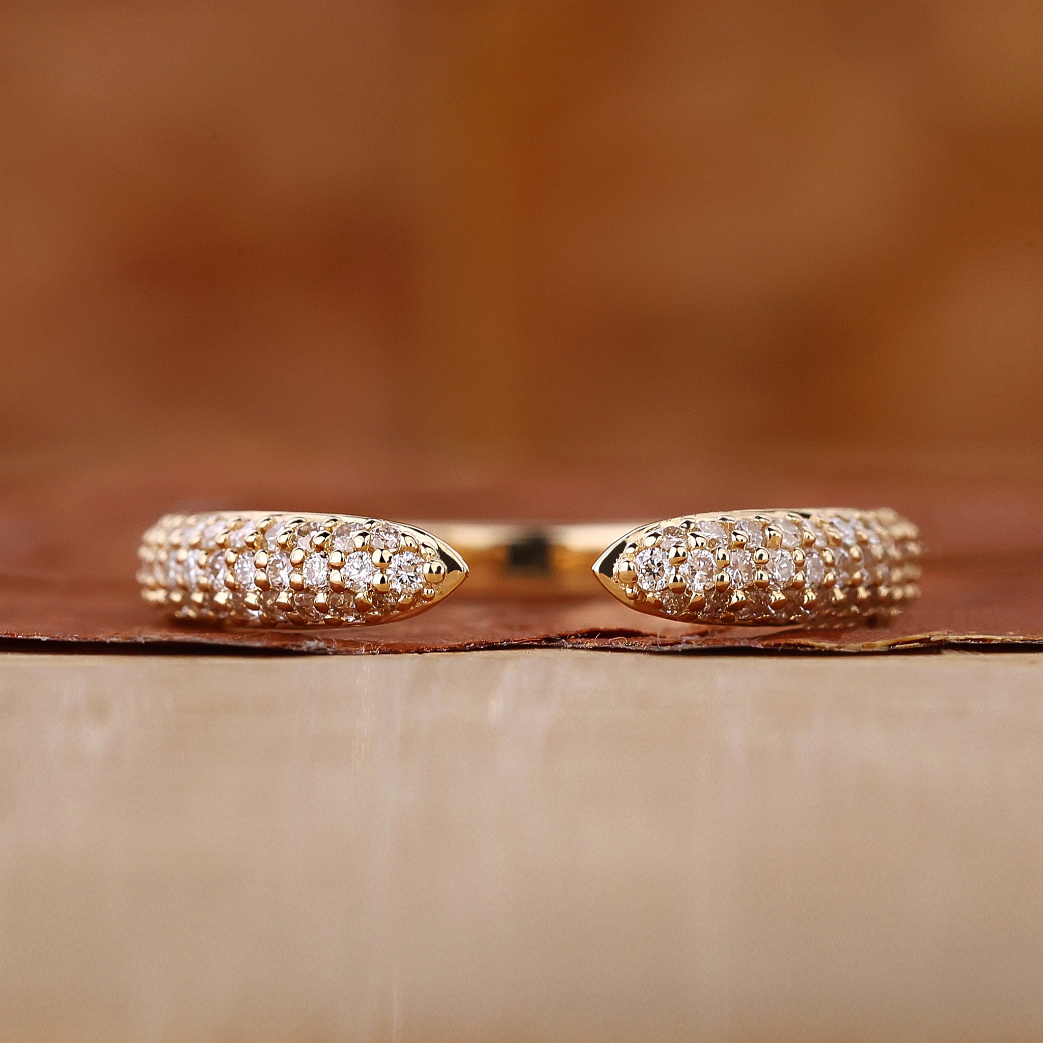 Three row pave diamond band in yellow gold.

