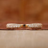 Three row pave diamond band in yellow gold.
