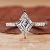 White gold engagement ring with a lozenge cut diamond.
