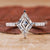 White gold engagement ring with a lozenge cut diamond.
