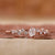 Oval diamond ring in rose gold setting.
