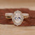 Oval diamond engagement ring with band.
