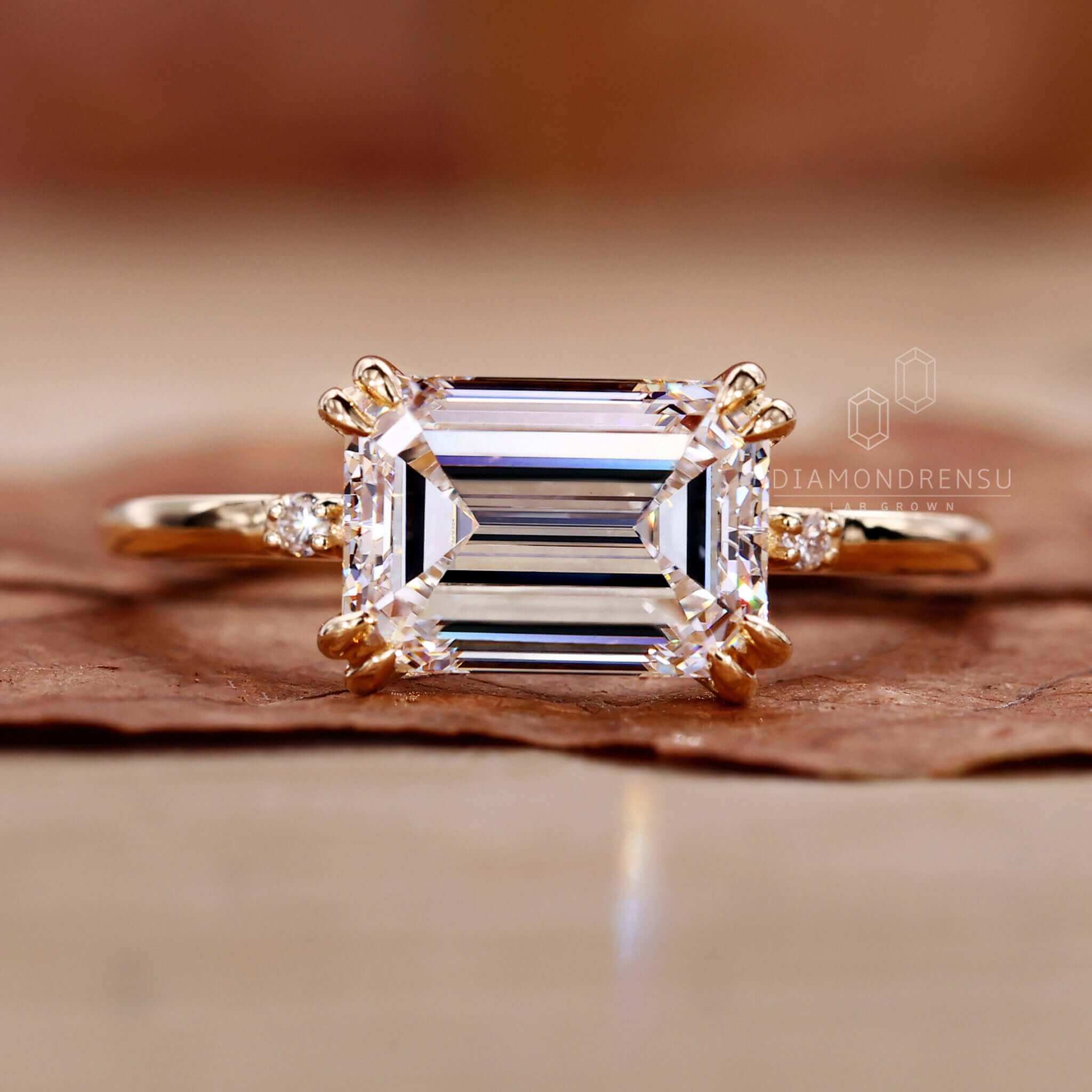 Emerald cut diamond ring featuring an elegant claw prong setting.