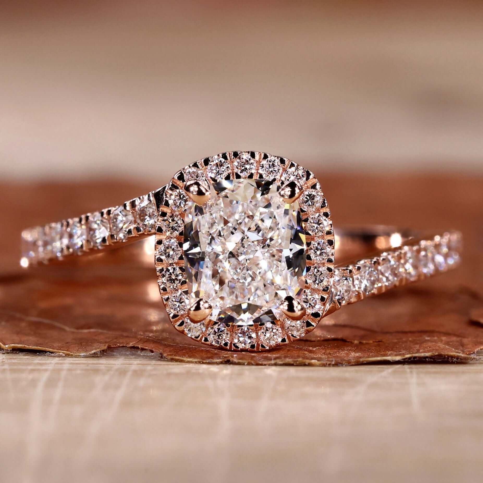 Close-up of a cushion cut engagement ring with intricate detailing.