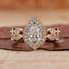Vintage style bridal set with pear diamond ring and halo engagement ring.
