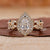 Vintage style bridal set with pear diamond ring and halo engagement ring.
