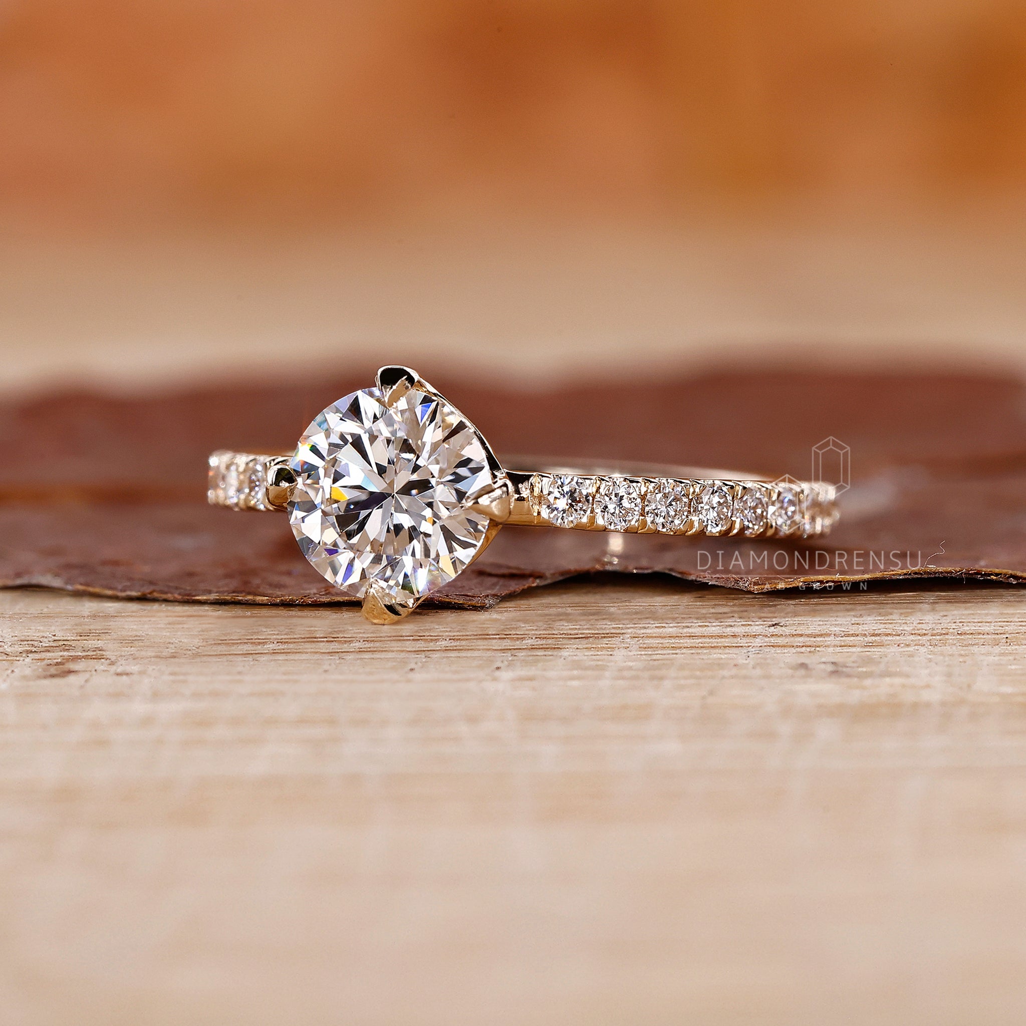 Proposal engagement ring with prong set ring design and yellow gold finish.
