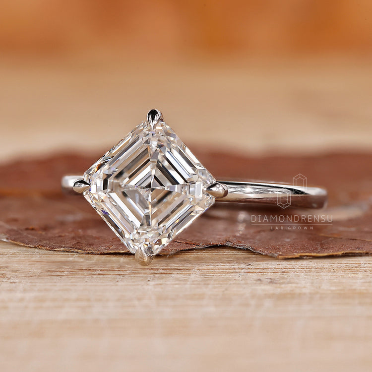 UK engagement ring features a solitaire style with asscher cut design.
