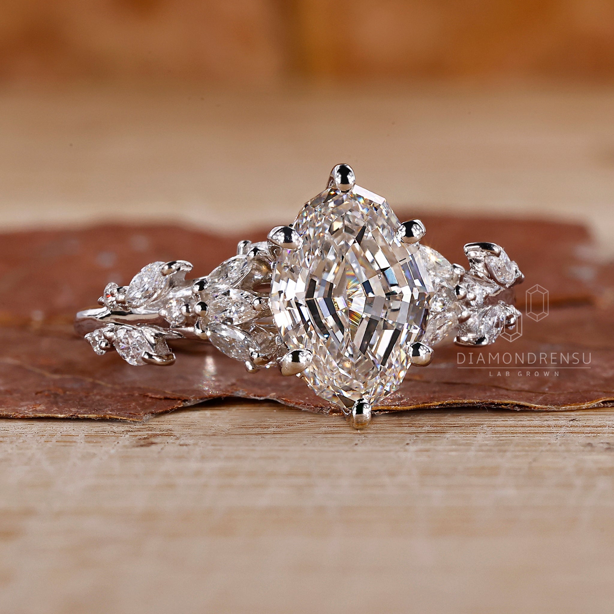 Nature inspired diamond ring with marquise and round side stones.