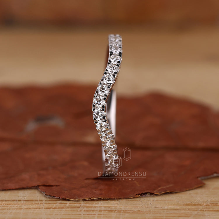 Lab diamond wedding band with curved design.
