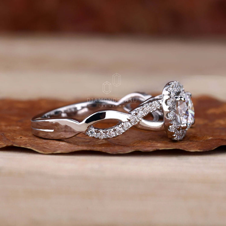 Twisted band engagement ring paired with a cushion halo engagement ring design for added brilliance.
