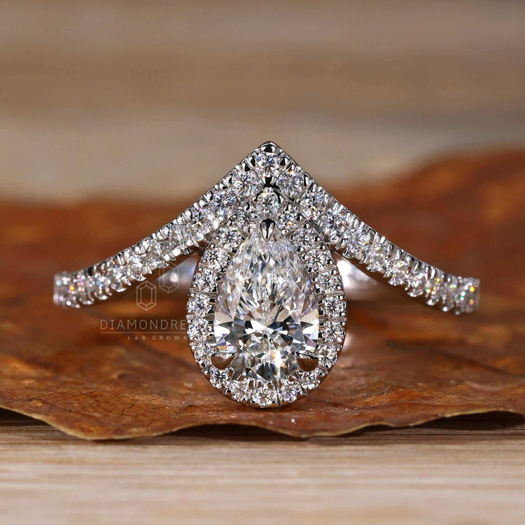 Pave diamond ring with a pear shaped diamond, creating a dazzling design for a uk engagement ring.
