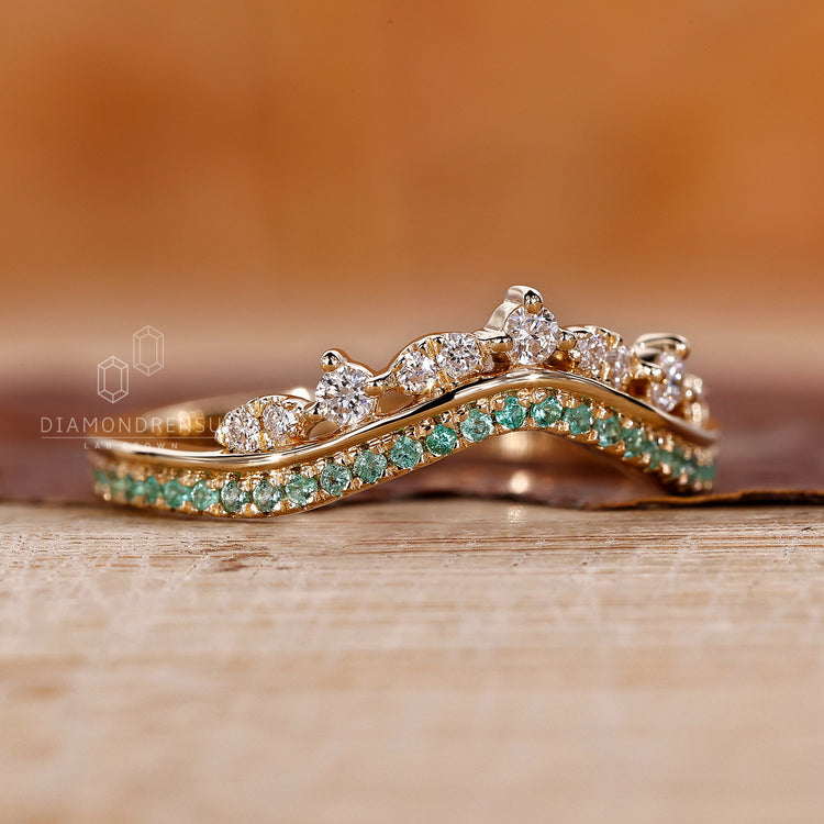 Lab grown emerald and diamond wedding ring.
