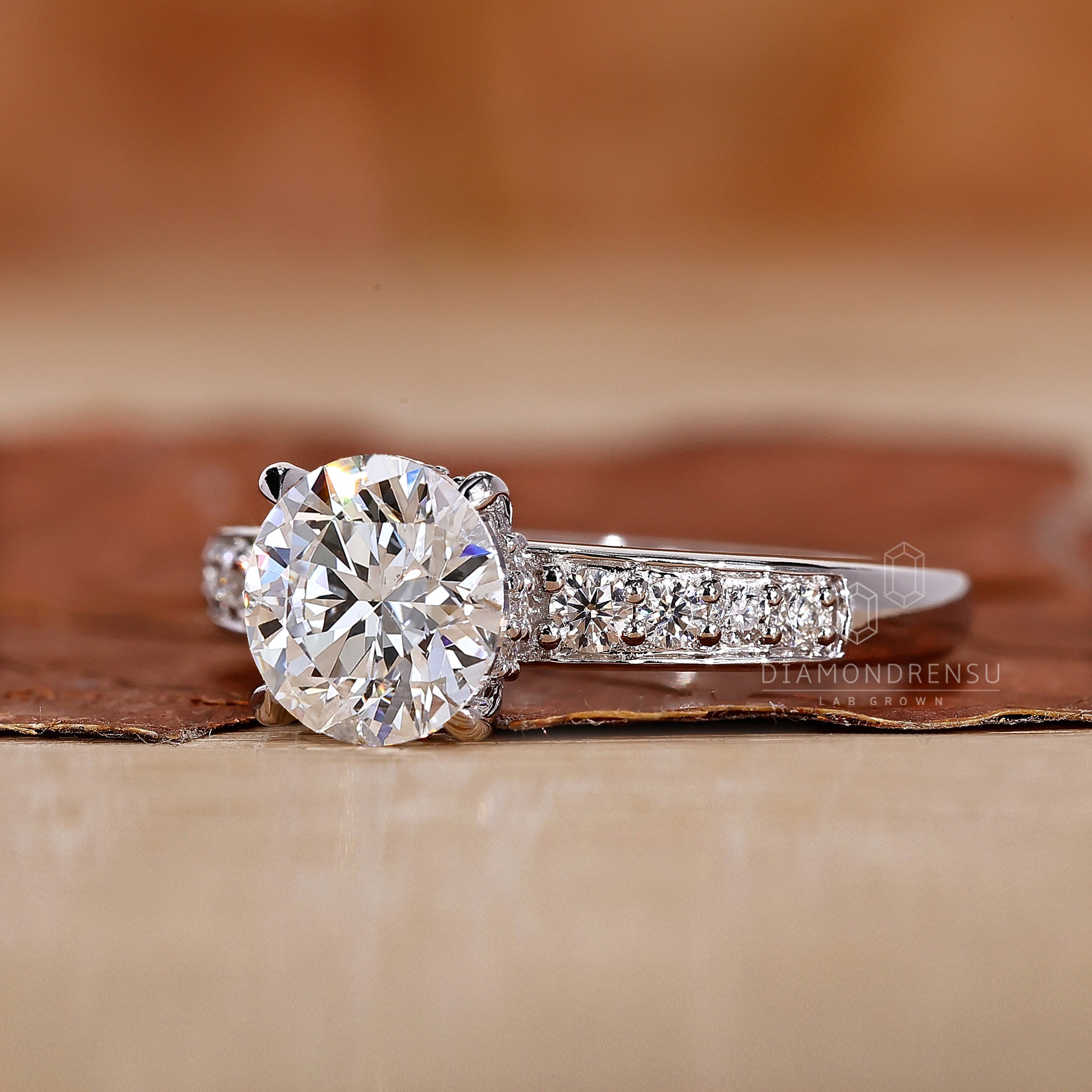 White gold diamond ring styled as hidden halo engagement ring.
