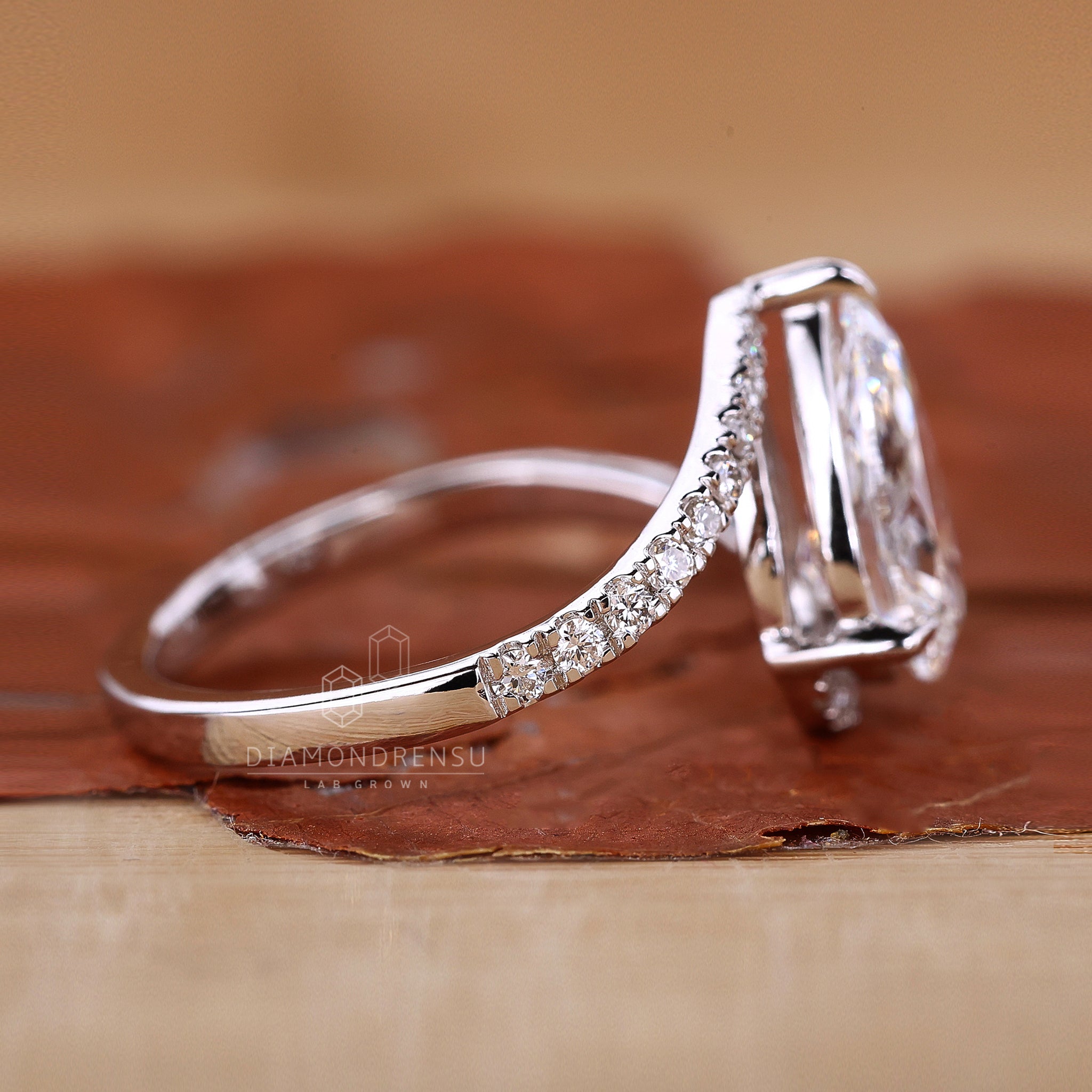 White gold engagement ring styled as pear diamond ring.
