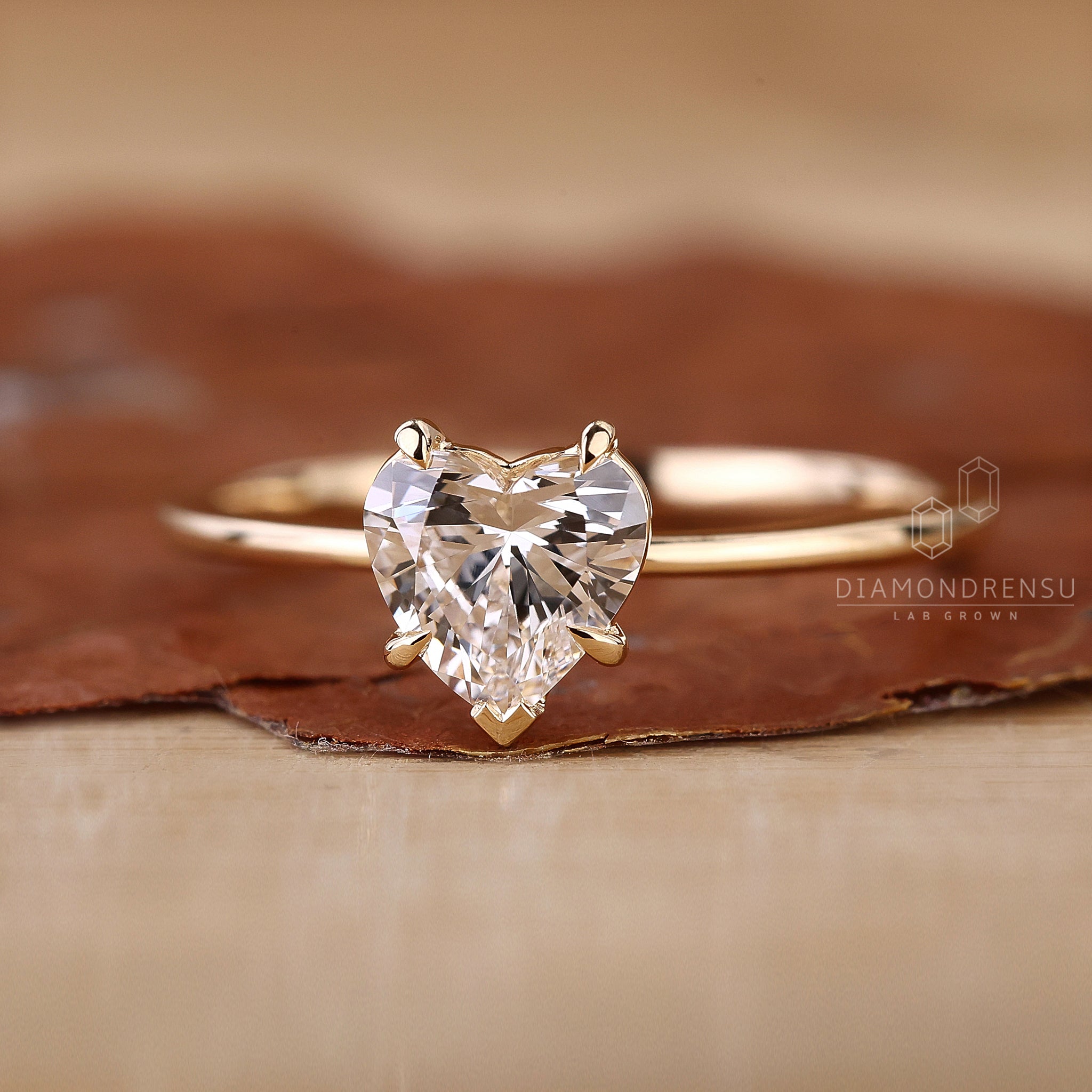 Heart diamond set in yellow gold band.
