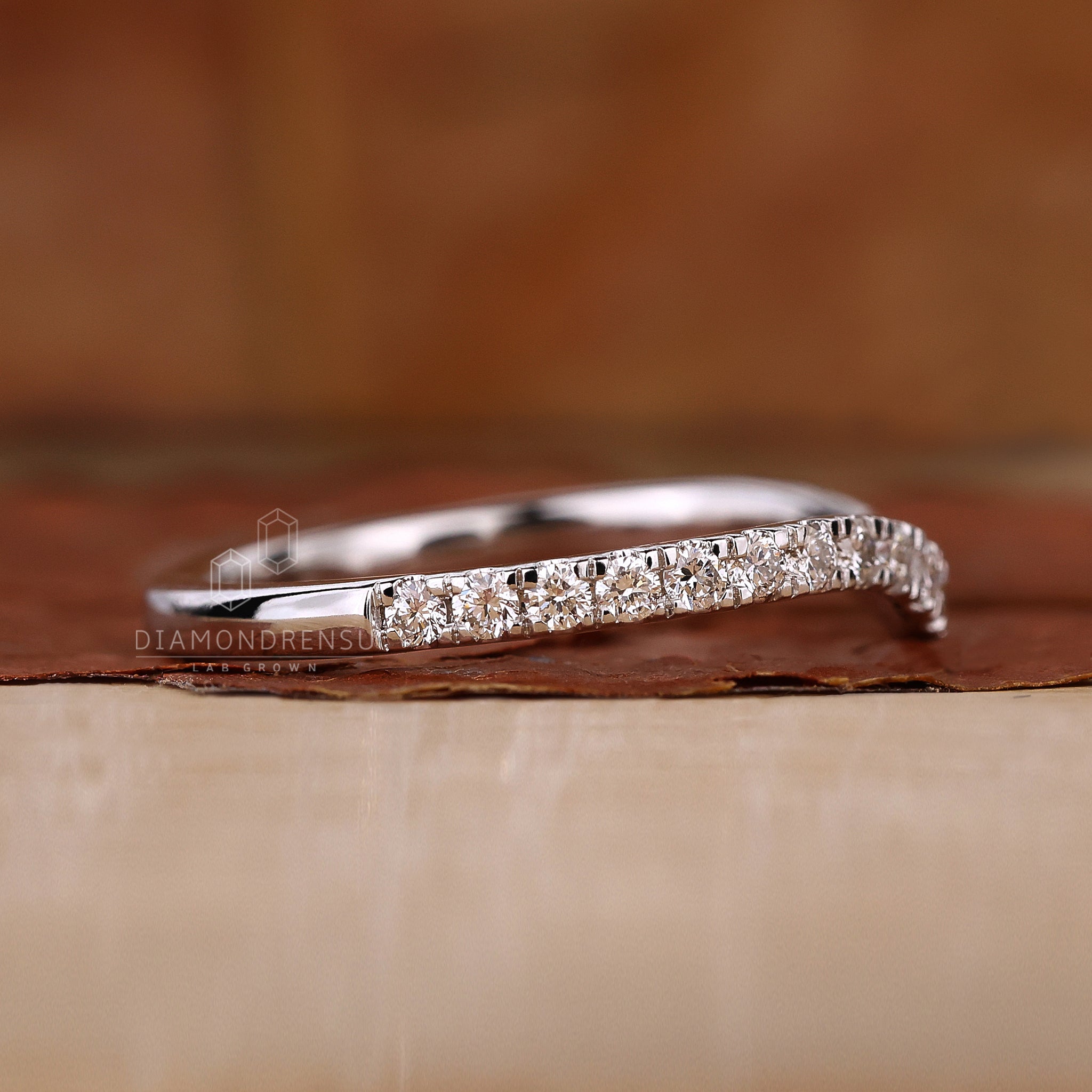 Elegant curved wedding band with lab grown diamonds.
