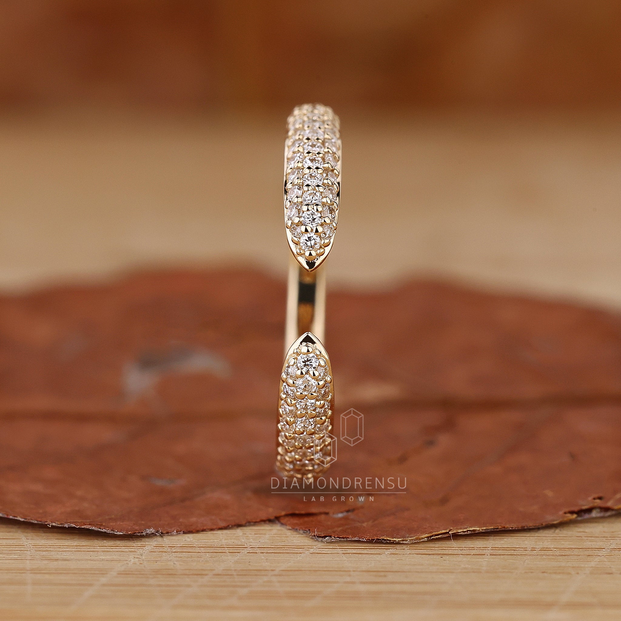 Yellow gold wedding band with round cut pave diamonds.
