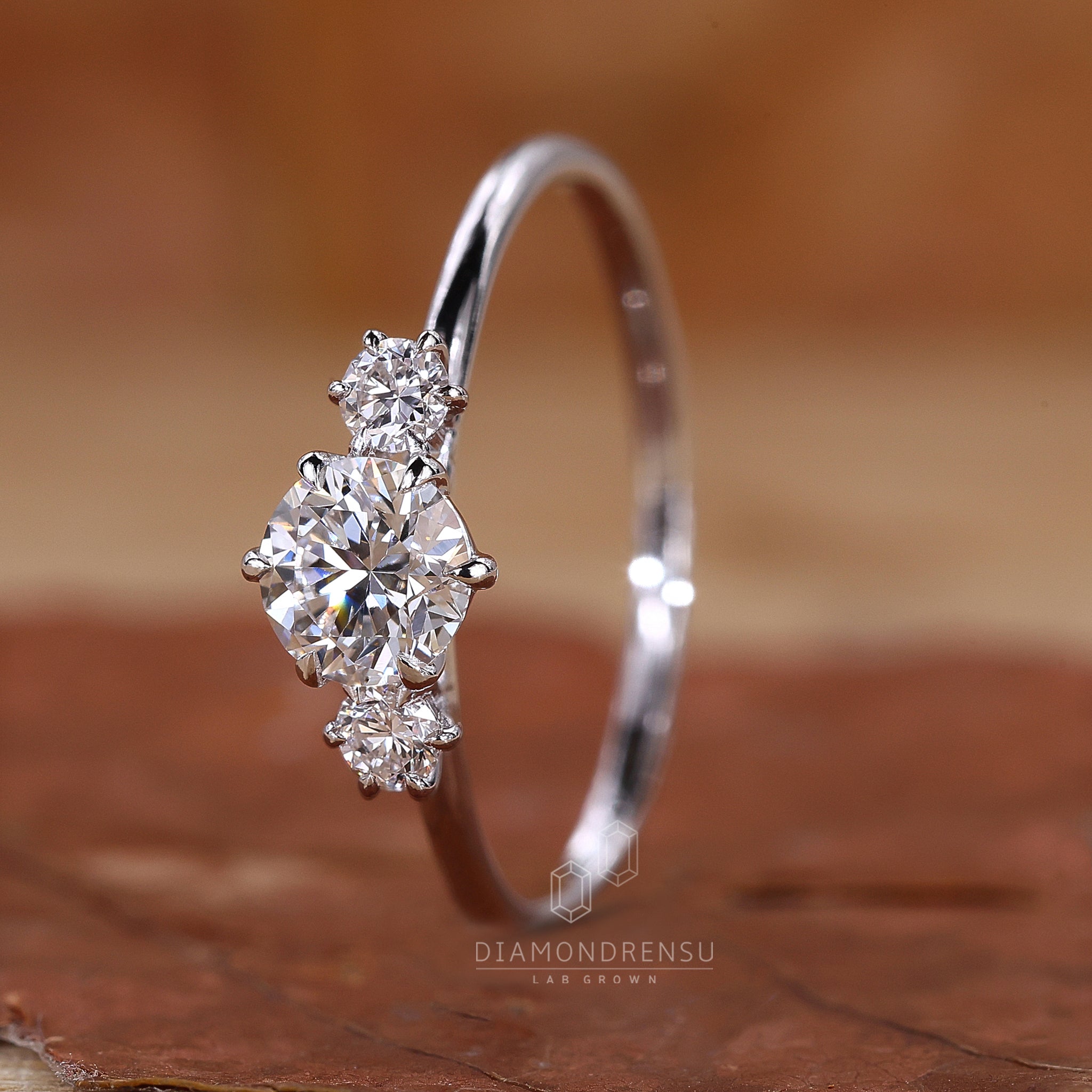White gold engagement ring with 3 stones.
