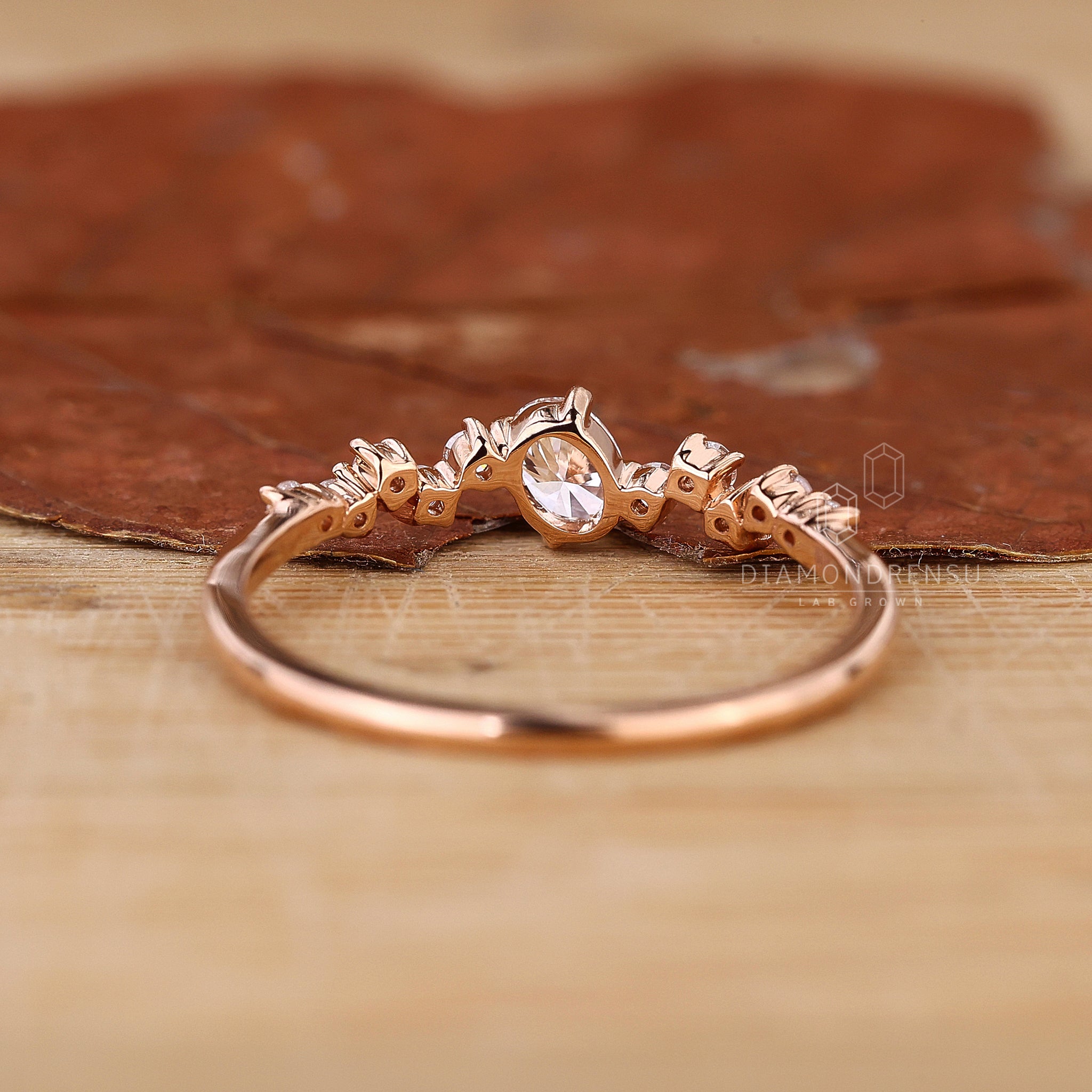 Rose gold engagement ring with oval diamond.
