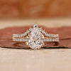 Pear shape engagement ring with band.
