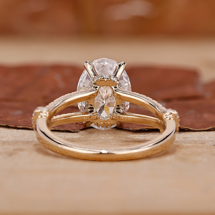 Round cut diamond halo ring with yellow gold ring band.

