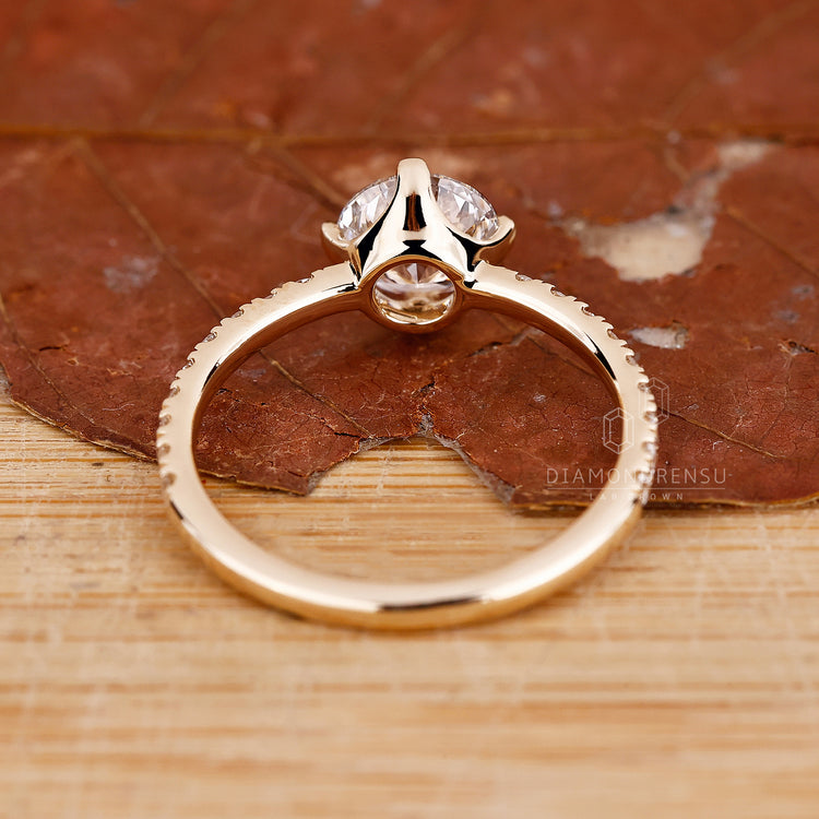 Yellow gold ring with round diamond and round diamond pave band.
