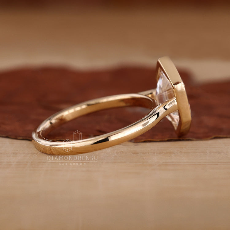 Custom engagement ring with yellow gold engagement ring finish.

