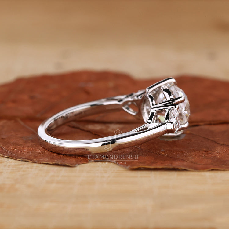 Round Old European cut with pear side stones.
