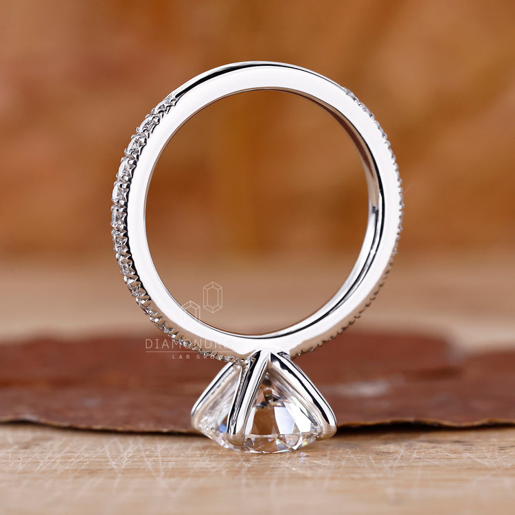 UK engagement ring with a round cut and pavé detailing.
