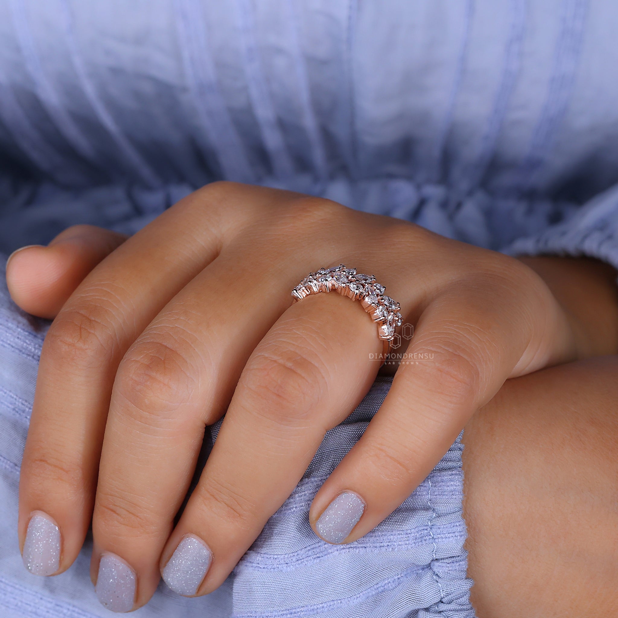 Round prong setting diamond wedding band in rose gold.

