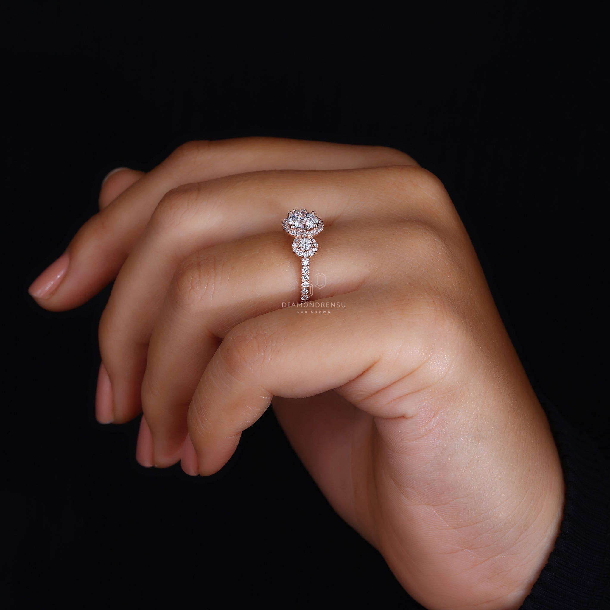 Bridge accent detail in 3 stone halo ring.

