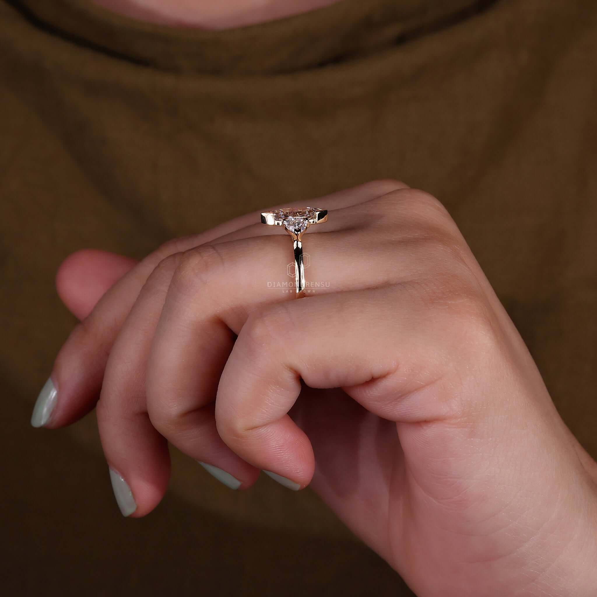 Three stone diamond ring displayed on a model's hand, perfect for any occasion.