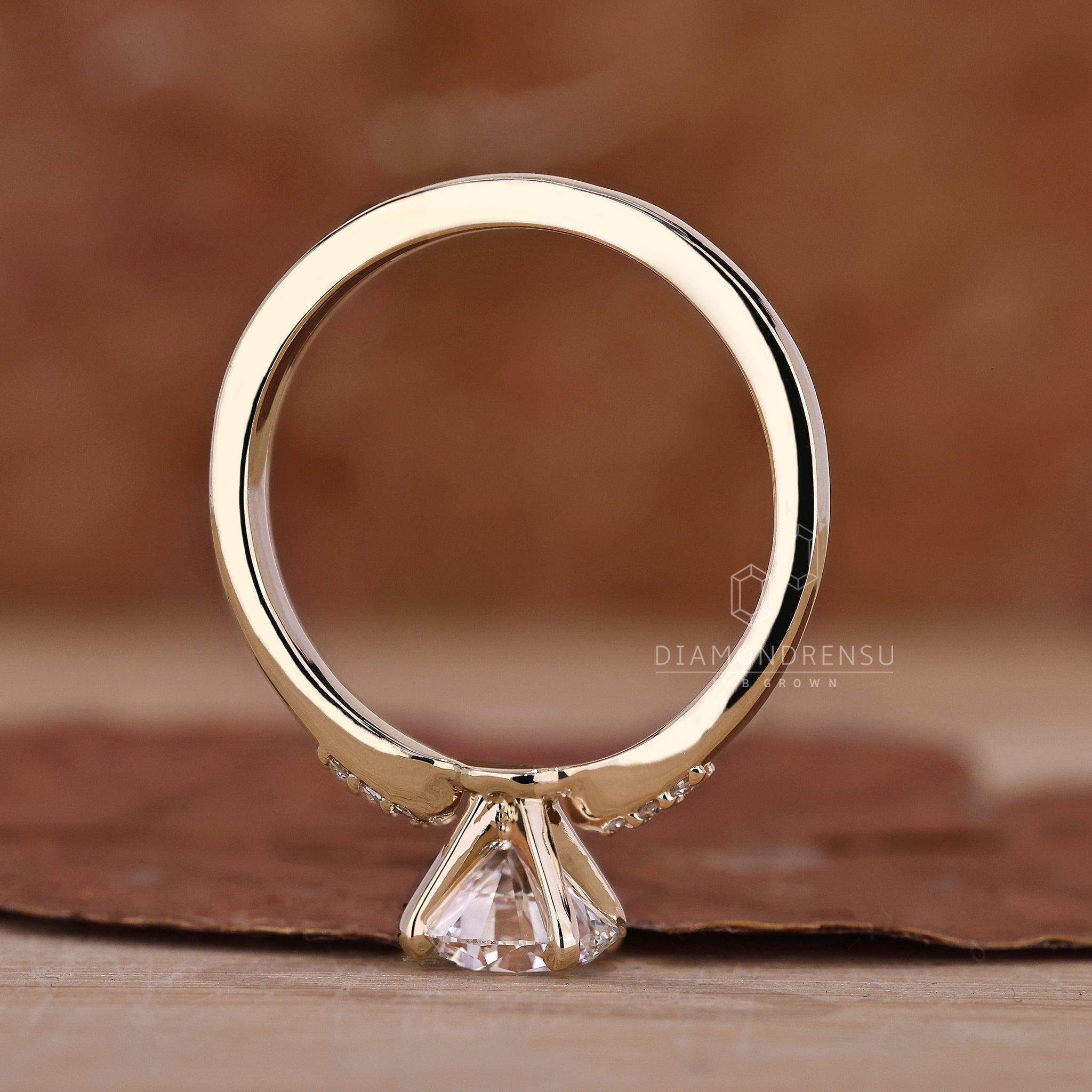 Round cut diamond ring featuring a delicate setting.
