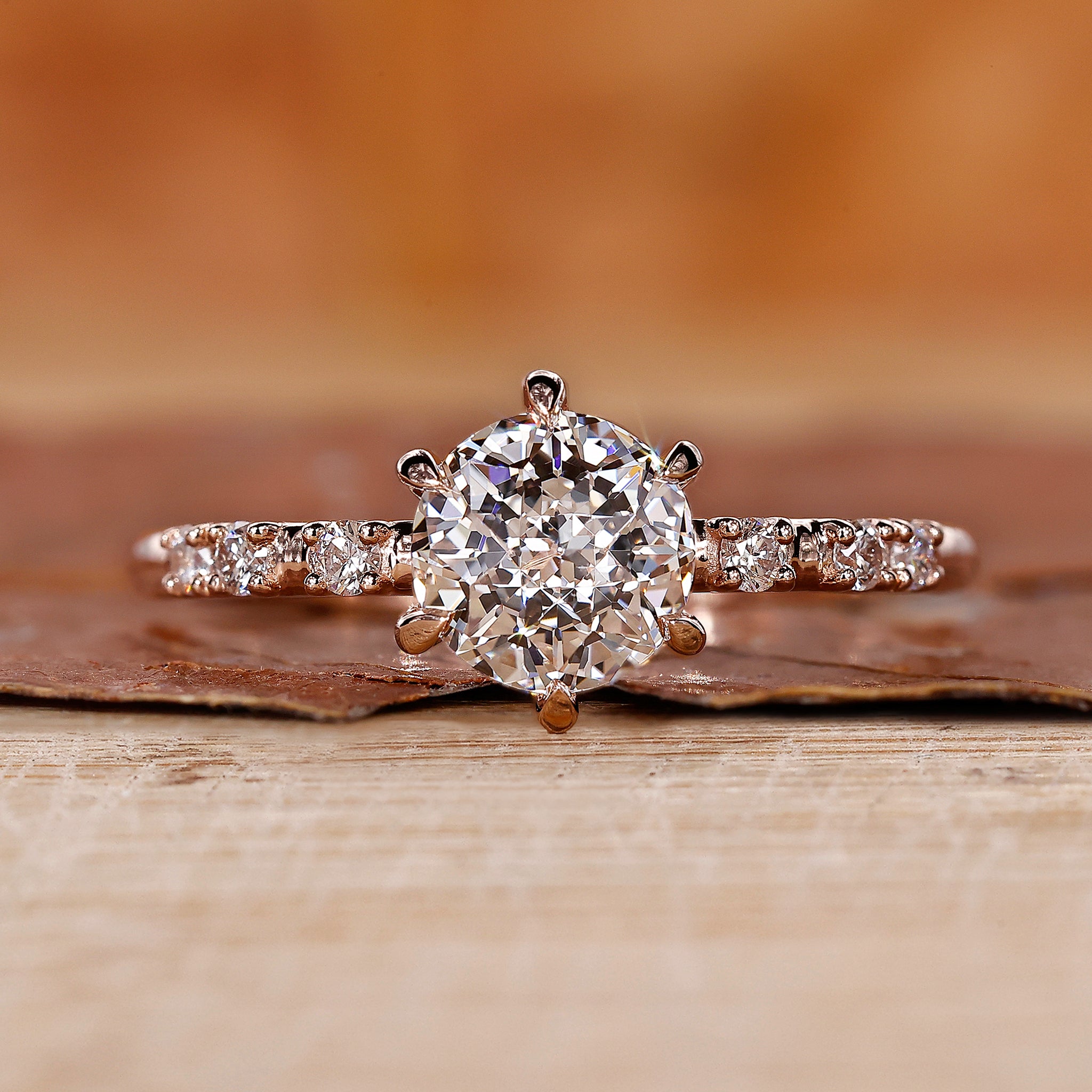 Pave Setting Ring with round cut side stone in rose gold.
