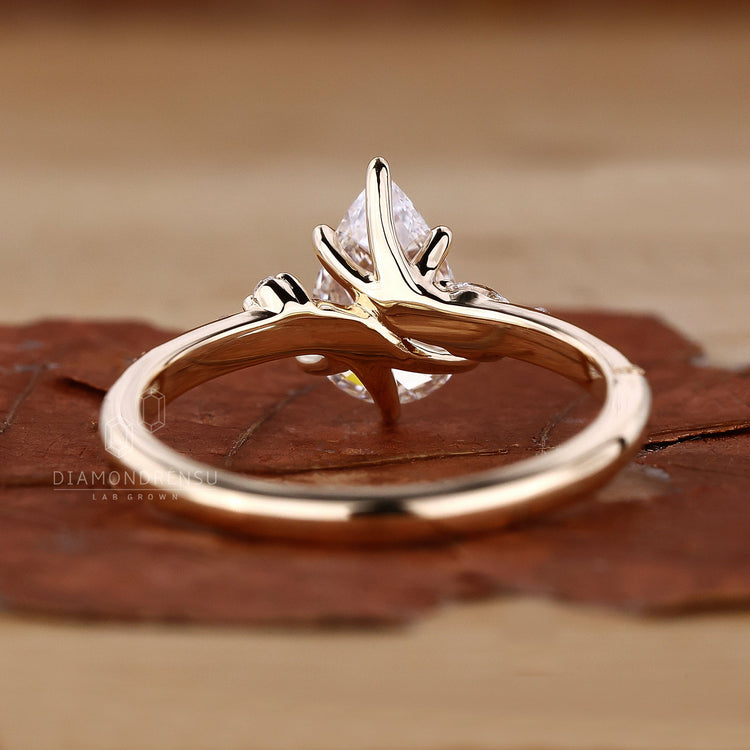 Diamond ring with marquise side stones in 6 prong claw setting.