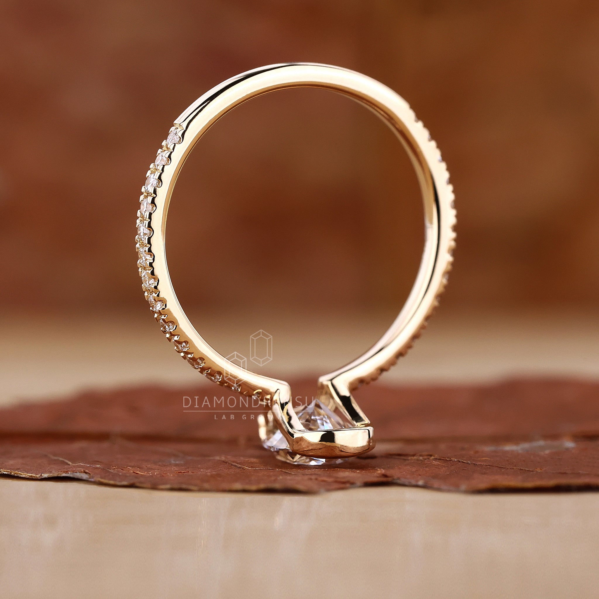 Unique half bezel ring in a classic yellow gold finish.