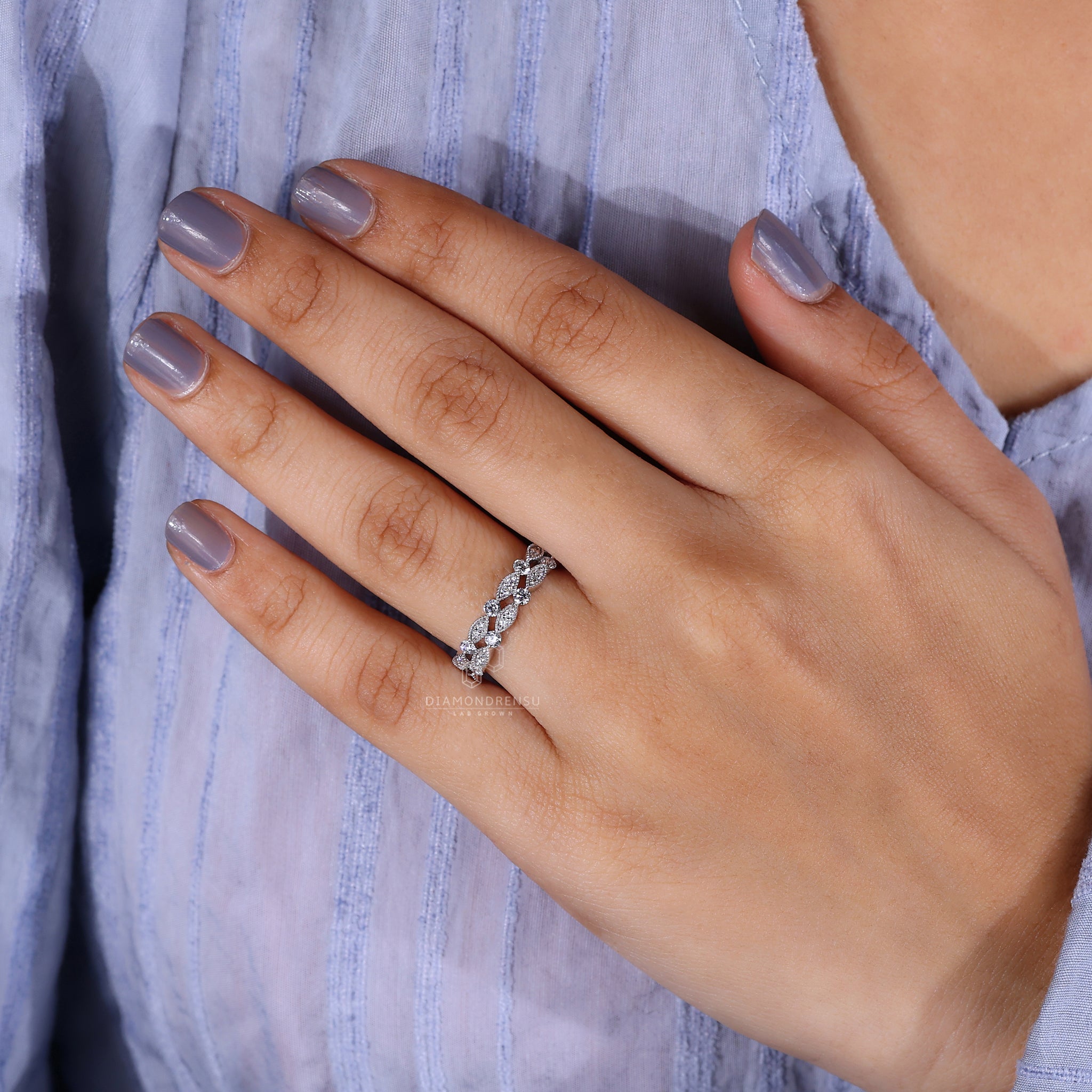 Round diamond wedding ring with marquise-inspired design
