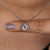 Close-up of solitaire diamond pendant in round prong setting