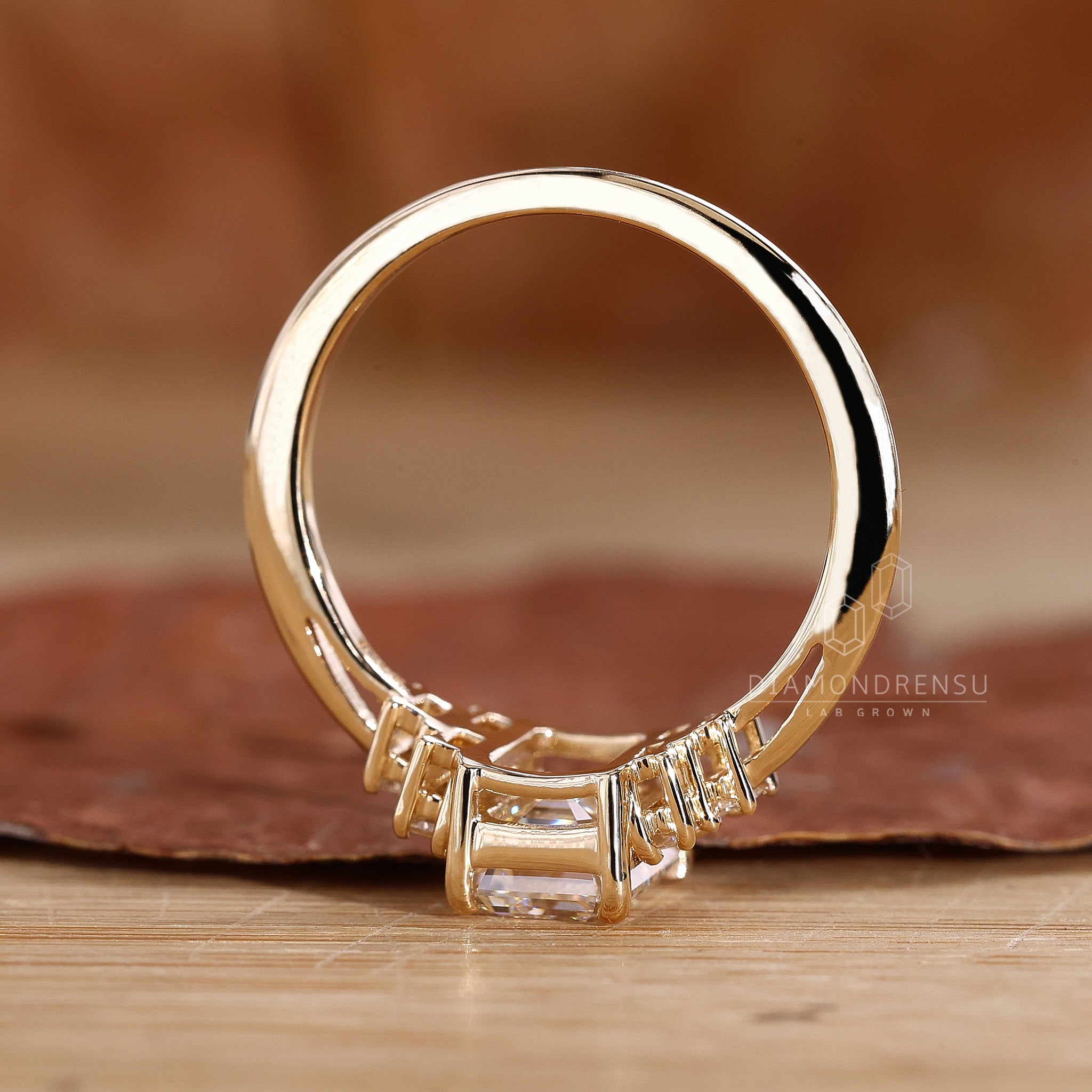 Lab grown diamond set in emerald cut engagement ring.
