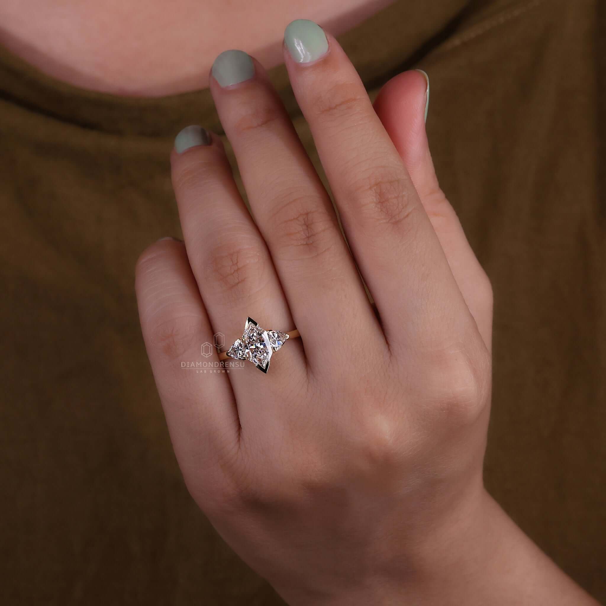 Elegant three stone diamond ring with dutch marquise and side trillion cut diamonds.