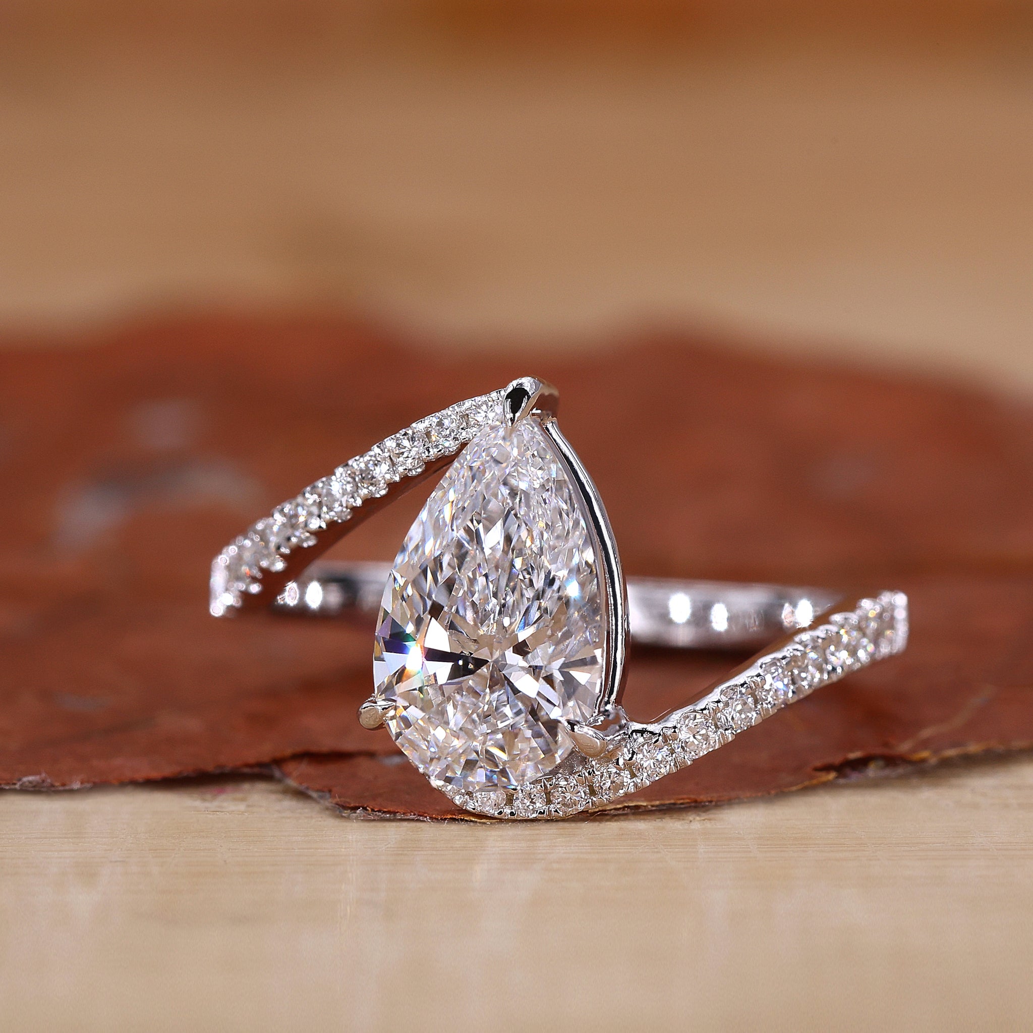 Pear diamond ring with bypass setting engagement ring.

