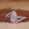 Pear diamond ring with bypass setting engagement ring.
