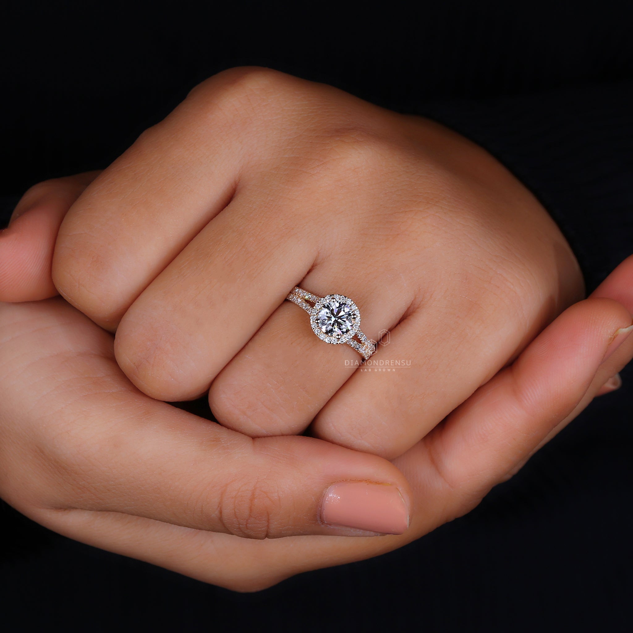Round diamond center stone with halo setting.
