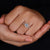 Round diamond center stone with halo setting.
