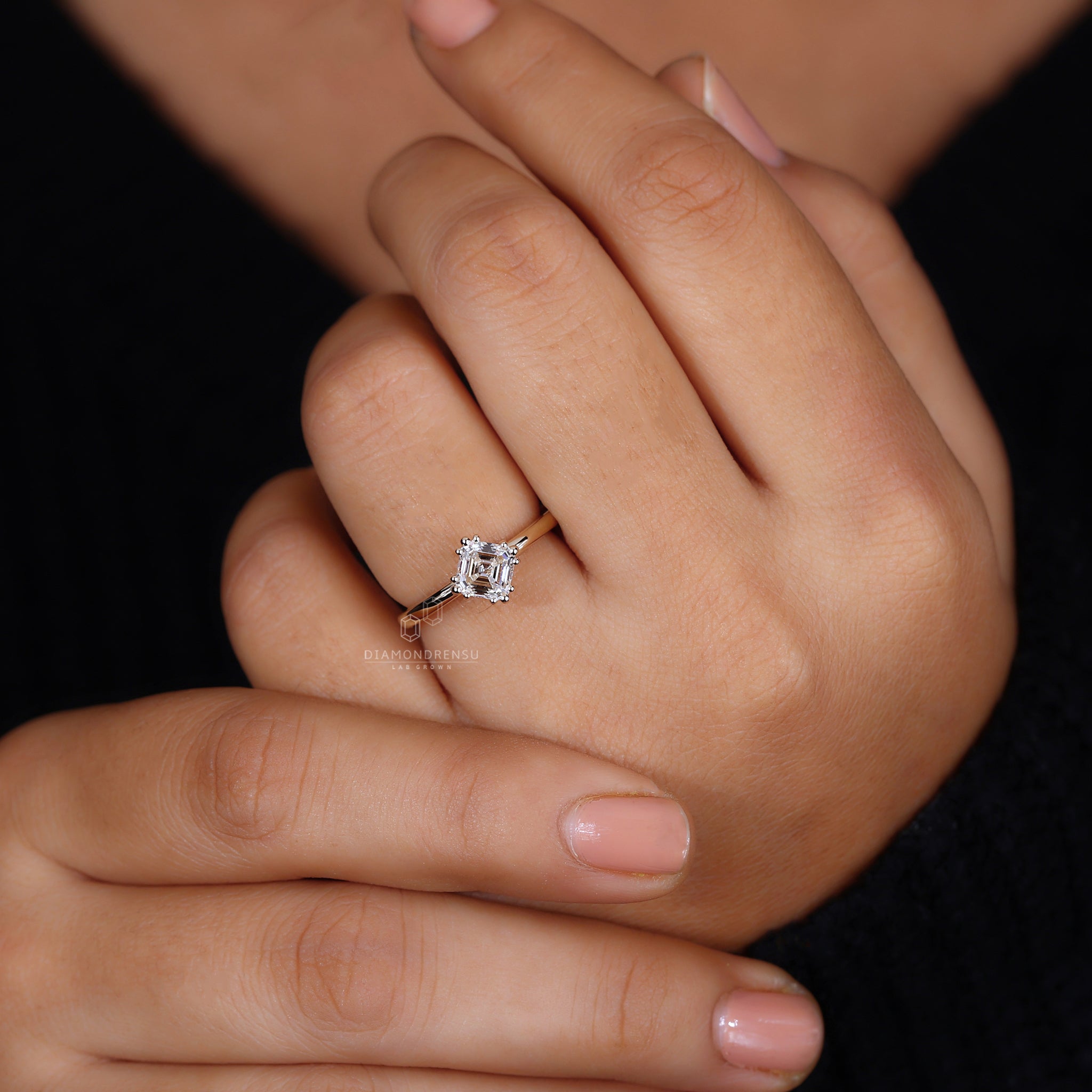 Asscher cut ring with triple compass prong style.

