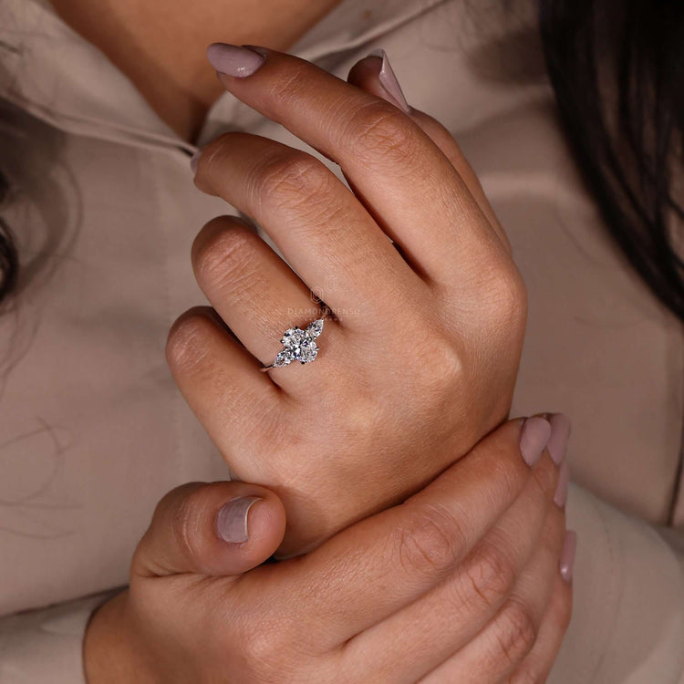 Oval shaped engagement ring with pear-shaped diamonds and igi certified craftsmanship for unmatched elegance.