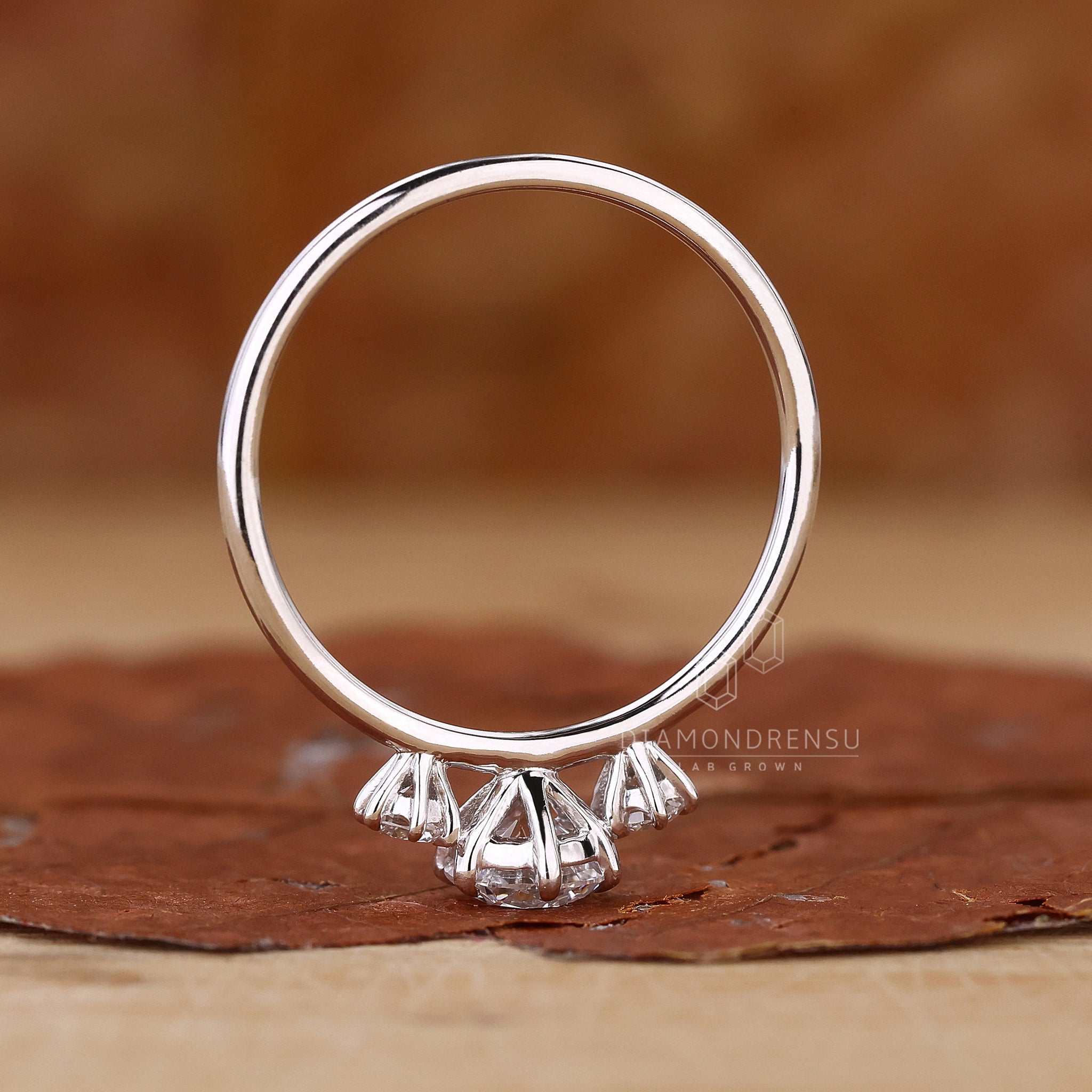 Lab diamond ring with three round stones.
