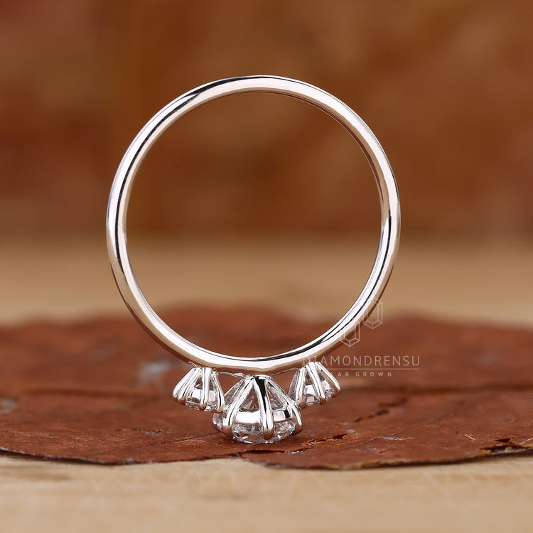 Lab diamond ring with three round stones.
