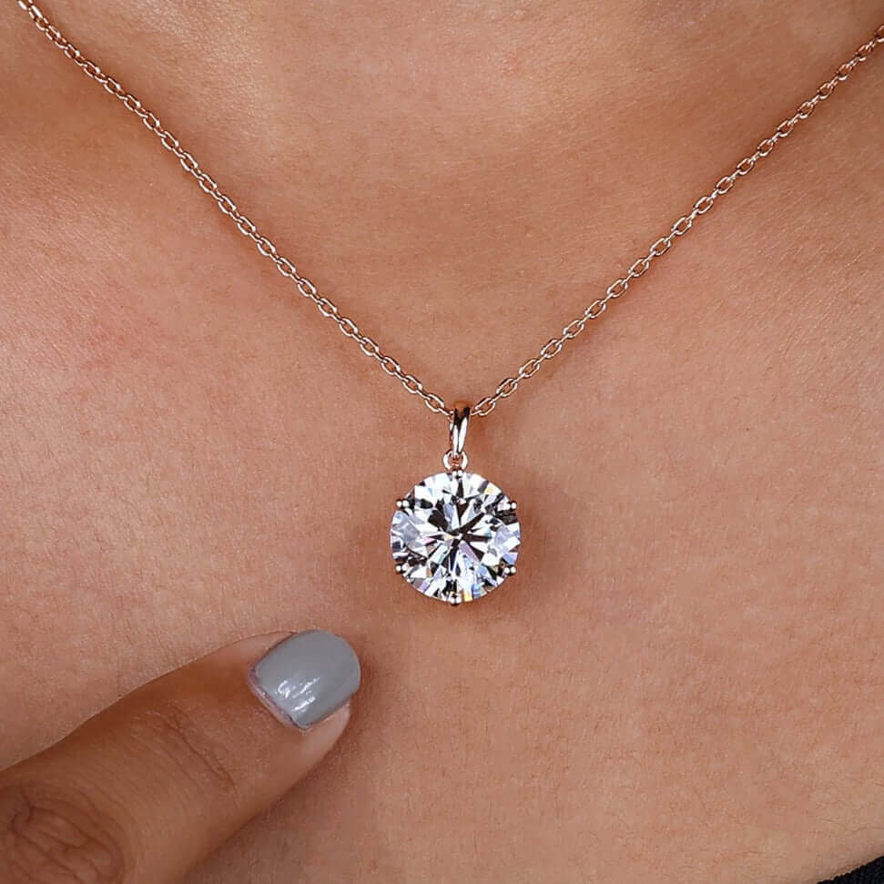 Model wearing a solitaire diamond pendant, showcasing its sparkle.